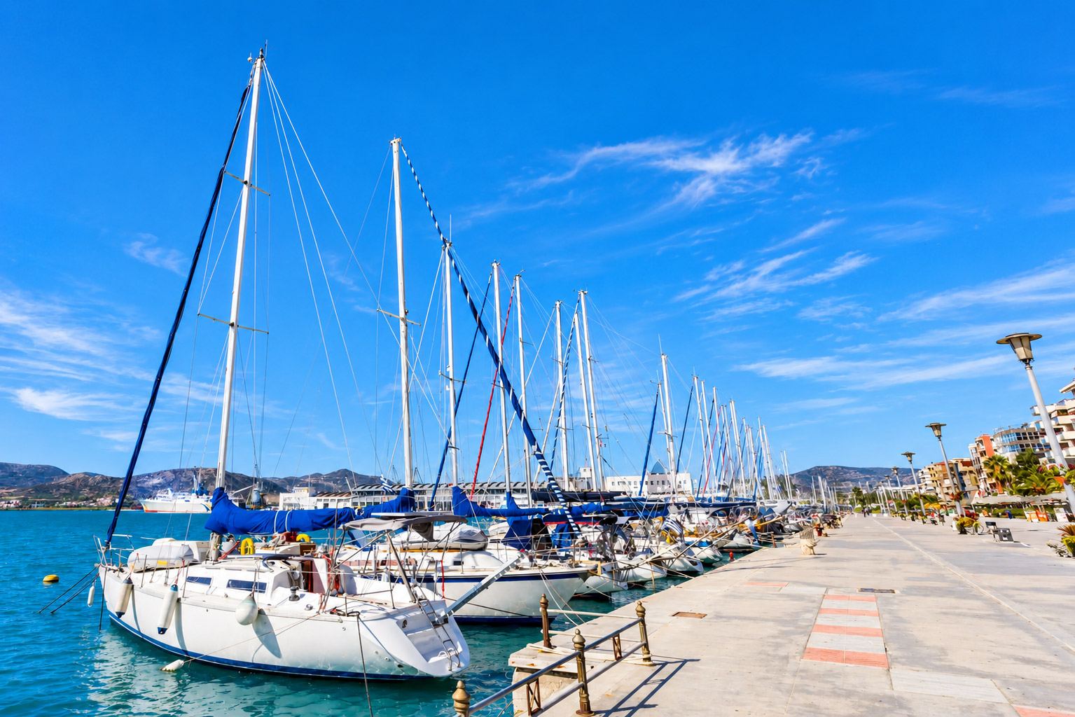 Marina with pontoons full of boats by the sea