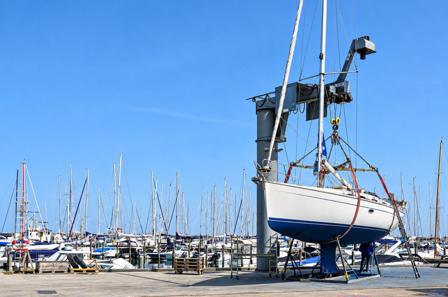Travel lift lifting a boat out of the water at the boatyard